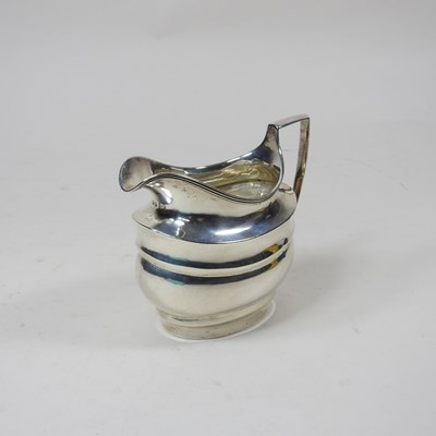 Lot 39 - A George III silver cream jug, London 1803,...
