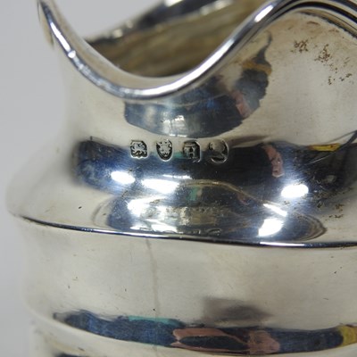 Lot 39 - A George III silver cream jug, London 1803,...