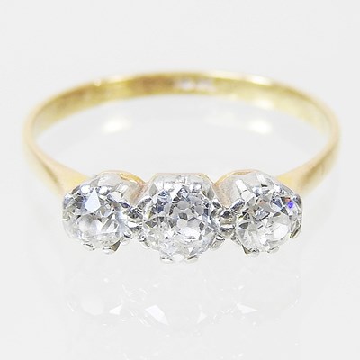 Lot 171 - An 18 carat gold three stone diamond ring,...