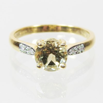 Lot 106 - A 9 carat gold topaz dress ring, with diamond...