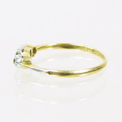 Lot 14 - An 18 carat gold three stone diamond ring,...