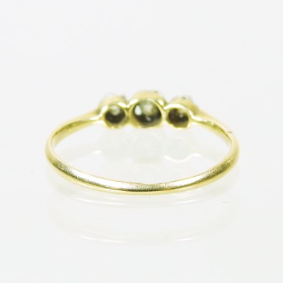 Lot 14 - An 18 carat gold three stone diamond ring,...
