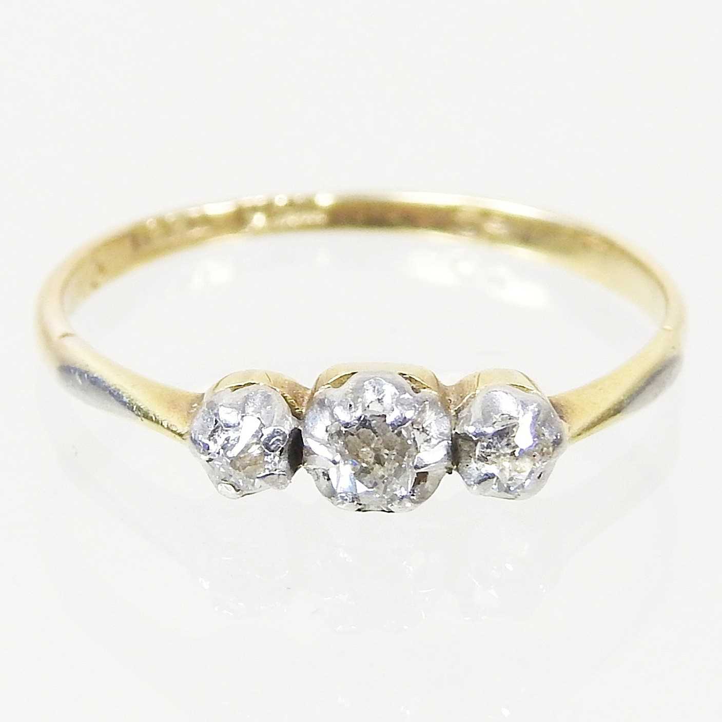Lot 14 - An 18 carat gold three stone diamond ring,...