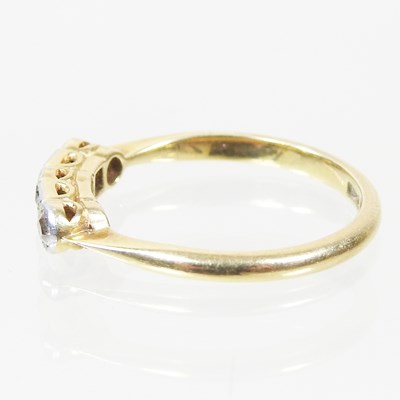 Lot 38 - A gold and platinum set five stone emerald and...