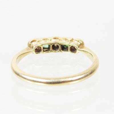 Lot 38 - A gold and platinum set five stone emerald and...