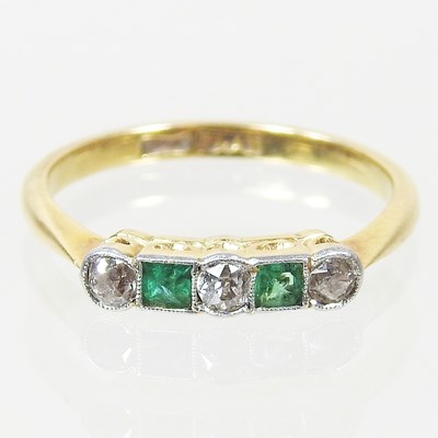 Lot 38 - A gold and platinum set five stone emerald and...