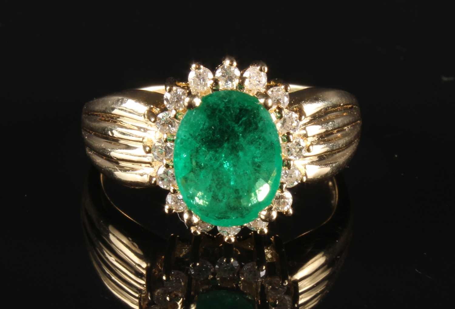 Lot 51 - A 14 carat emerald and diamond cluster ring,...