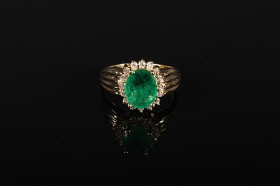 Lot 51 - A 14 carat emerald and diamond cluster ring,...