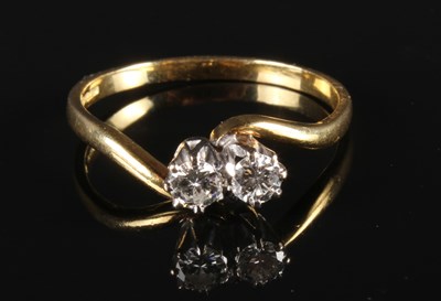 Lot 54 - An 18 carat gold diamond two stone crossover...