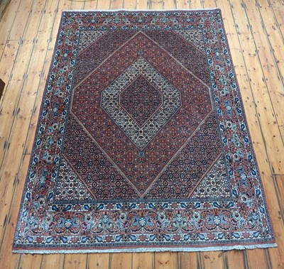 Lot 265 - A Persian rug, intricately decorated with...