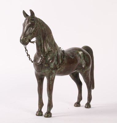 Lot 65 - A bronze model of a horse, shown standing with...