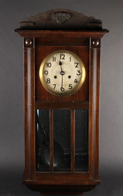 Lot 651 - A 1920s oak wall clock, h.71cm