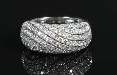 Lot 8 - An 18 carat white gold diamond dome ring,...
