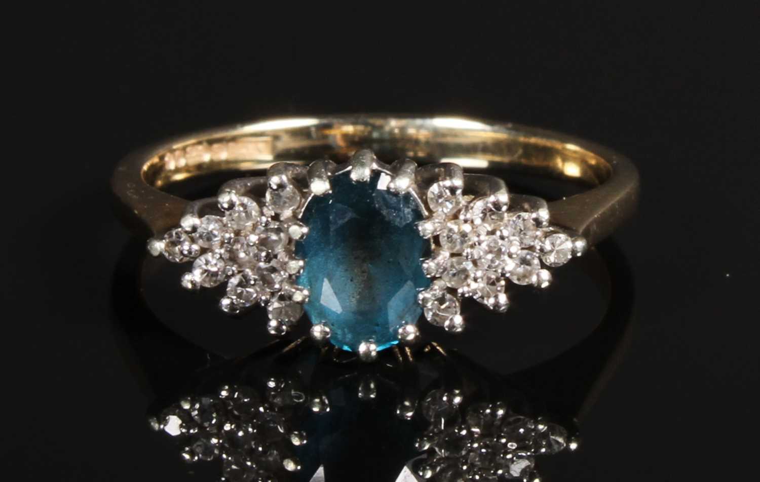 Lot 94 - A 9 carat blue topaz and diamond dress ring,...