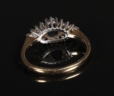 Lot 94 - A 9 carat blue topaz and diamond dress ring,...