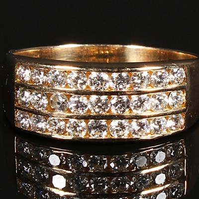 Lot 95 - An 18 carat gold diamond three row channel set...