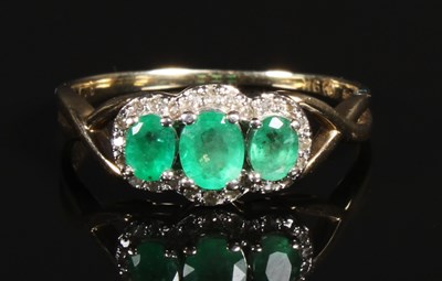 Lot 160 - A 9 carat yellow gold emerald and diamond ring,...