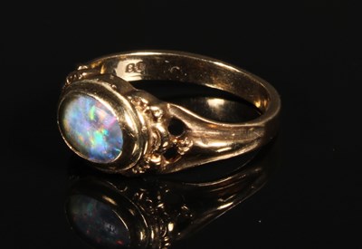 Lot 64 - A 9 carat yellow gold opal ring, size K/L, 2.4g