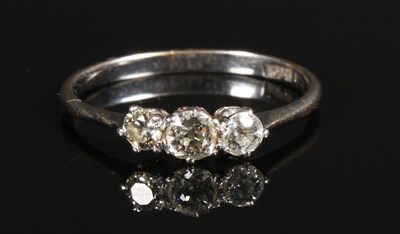 Lot 154 - An 18 carat white gold three stone diamond...