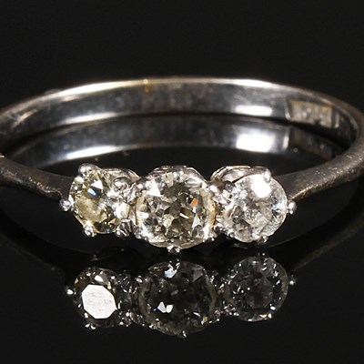 Lot 204 - An 18 carat white gold three stone diamond...