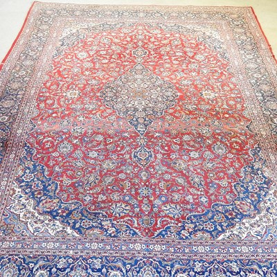 Lot 33 - A large Persian kashan carpet, with scrolling...