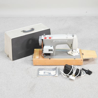 Lot 276 - A Frister & Rossman electric sewing machine,...