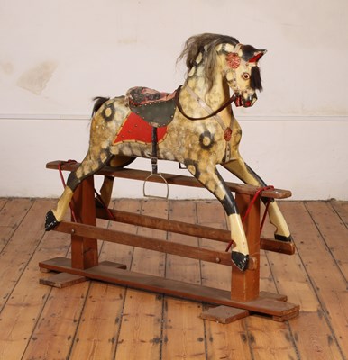 Lot 568 - A vintage painted wooden rocking horse