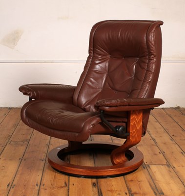 Lot 414 - A Danish brown leather swivel reclining armchair