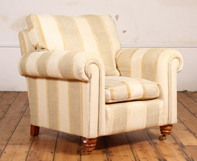 Lot 514 - A modern cream upholstered armchair