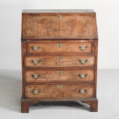Lot 472 - An early 20th century walnut bureau, of small...