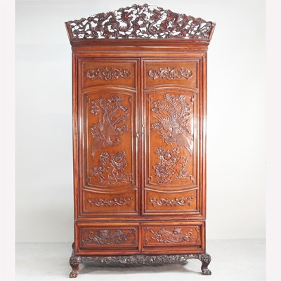 Lot 103 - A large Indonesian carved hardwood cupboard,...