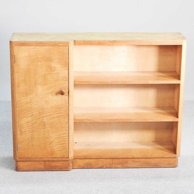 Lot 340 - An Art Deco maple open bookcase cabinet, on a...