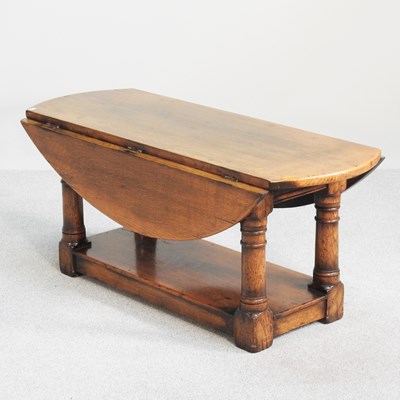 Lot 519 - A 20th century oak drop leaf occasional table,...