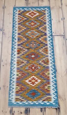 Lot 416 - A Chobi kilim runner, with a row of central...