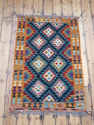 Lot 452 - A Persian kilim rug, with rows of coloured...