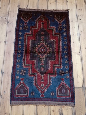 Lot 413 - A Baluchi rug, with a large central hooked...