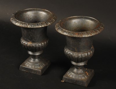 Lot 611 - A pair of small cast iron campana garden urns