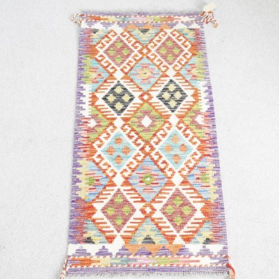 Lot 209 - A kilim runner, with two rows of hooked...