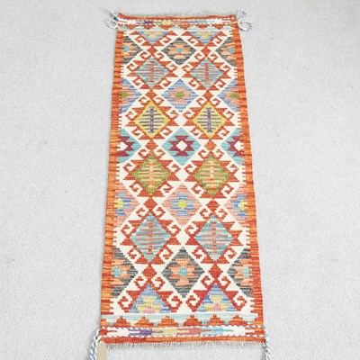 Lot 532 - A kilim runner, with two rows of hooked...