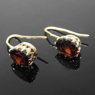 Lot 80 - A pair of 9 carat gold and garnet pendant...