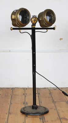 Lot 750 - A pair of 1910s brass head lamps, mounted on a...