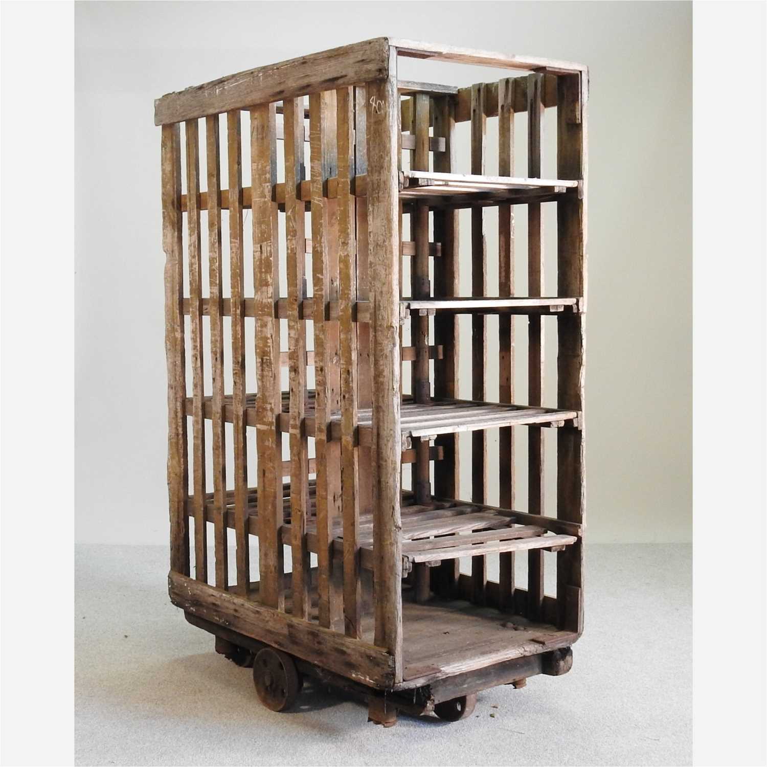 Lot 86 - An early 20th century pine rack, on metal