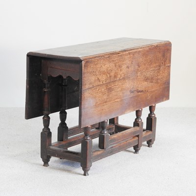 Lot 315 - An 18th century oak gateleg dining table, on...