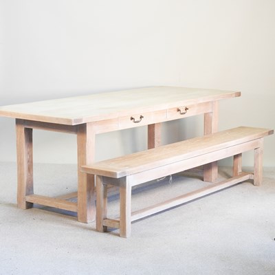 Lot 230 - A limed oak dining table, with two frieze...
