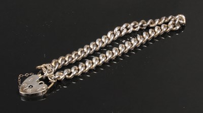 Lot 83 - A silver curblink bracelet and heart padlock...