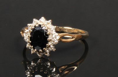 Lot 24 - A 9 carat sapphire and diamond cluster ring,...