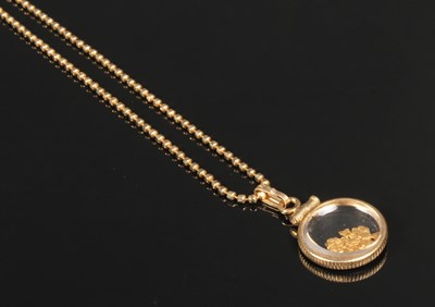 Lot 14 - A 14 carat yellow gold panning flakes pendant...