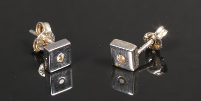 Lot 79 - A pair of 9 carat white gold ear studs