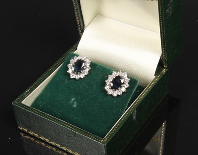 Lot 29 - A pair of sapphire and diamond cluster earrings
