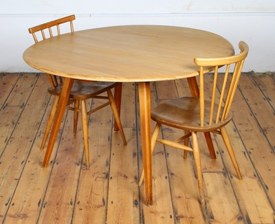 Lot 479 - An Ercol blonde elm drop-leaf dining table, on...